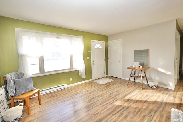 foyer entrance featuring light hardwood / wood-style floors and a baseboard heating unit