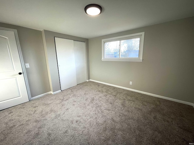 unfurnished bedroom with a closet and carpet