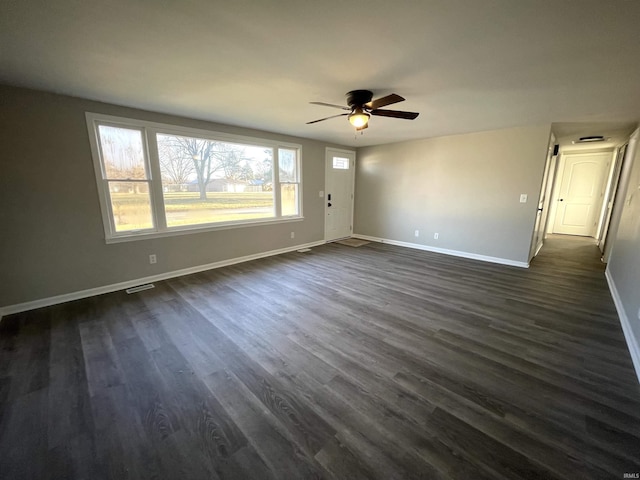 empty room featuring ceiling fan and dark hardwood / wood-style floors