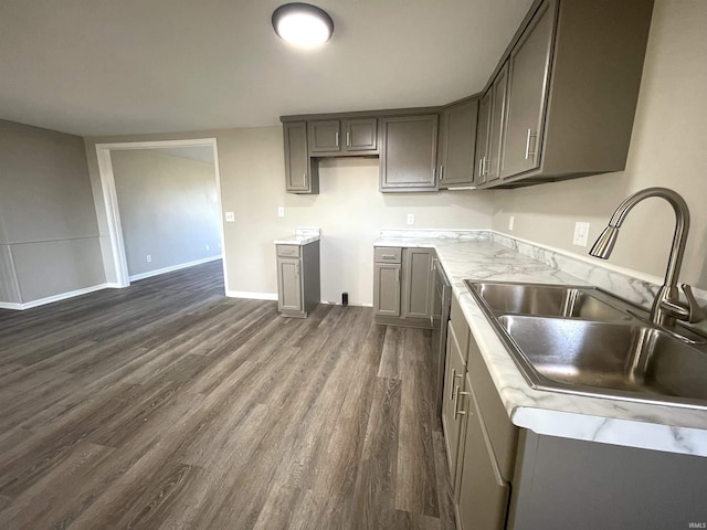 kitchen with gray cabinets, dark hardwood / wood-style flooring, and sink