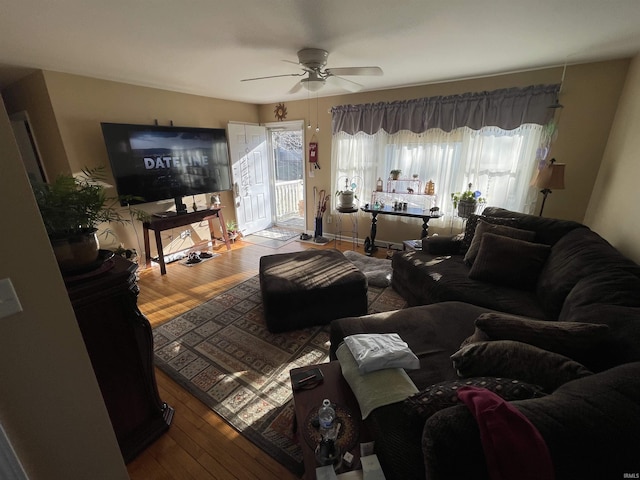 living room featuring hardwood / wood-style floors and ceiling fan