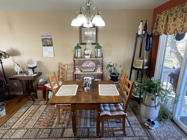 dining space featuring dark hardwood / wood-style floors and a notable chandelier