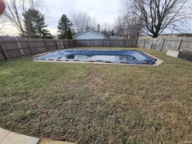 view of pool with a lawn