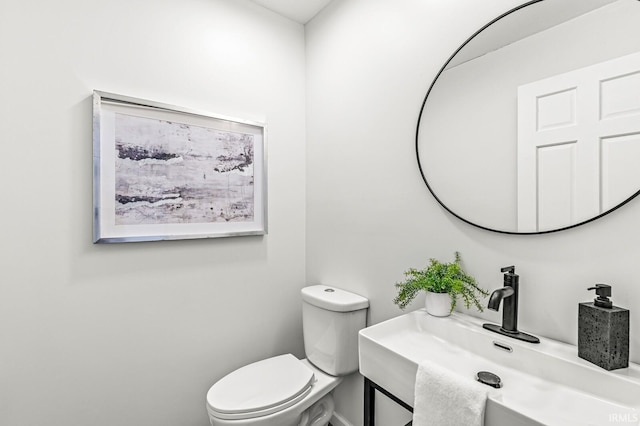 bathroom featuring toilet and sink