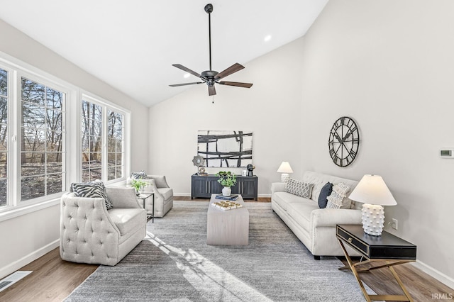 living room with wood-type flooring, high vaulted ceiling, and ceiling fan