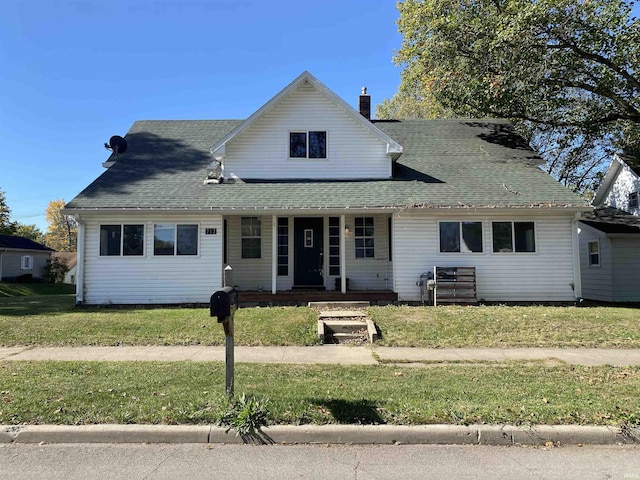 view of front of house with covered porch and a front lawn