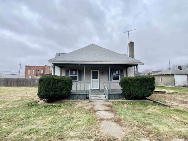 bungalow with a porch and a front yard