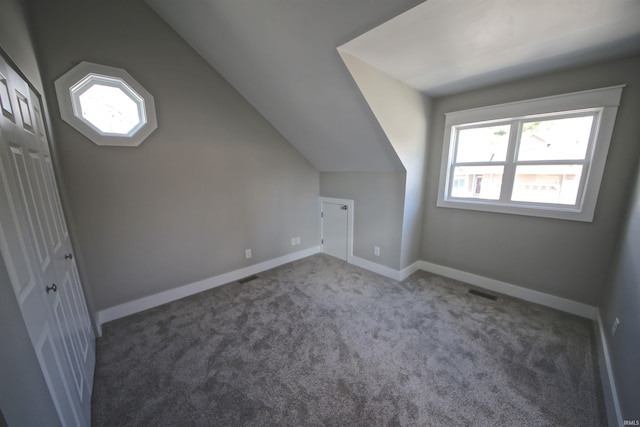 bonus room with carpet and vaulted ceiling