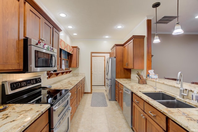 kitchen with sink, light tile patterned floors, ornamental molding, decorative light fixtures, and stainless steel appliances