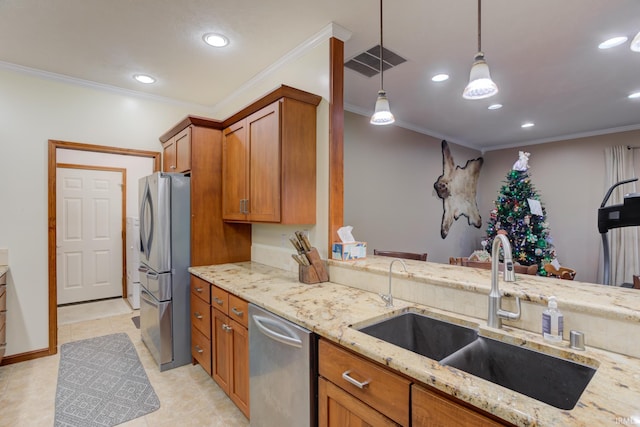 kitchen with sink, stainless steel appliances, hanging light fixtures, light stone counters, and ornamental molding