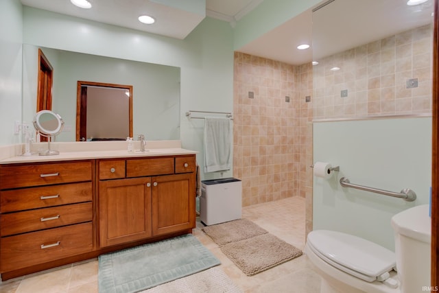 bathroom with tile patterned flooring, a shower, toilet, vanity, and tile walls