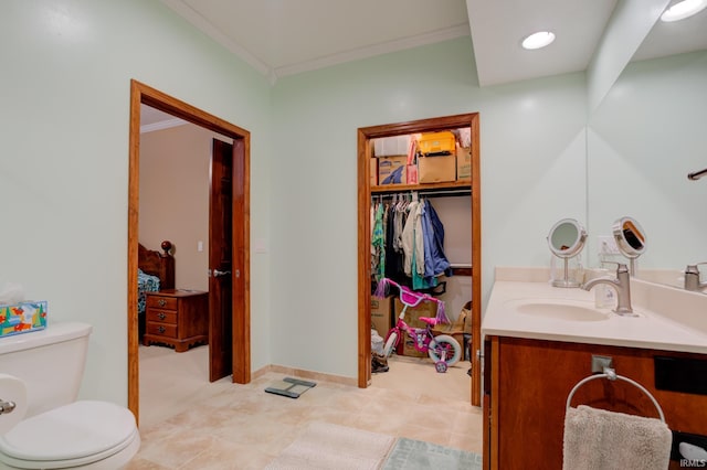 bathroom featuring tile patterned floors, vanity, toilet, and crown molding