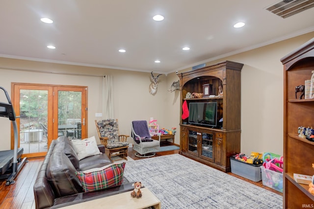 living room with crown molding and hardwood / wood-style flooring