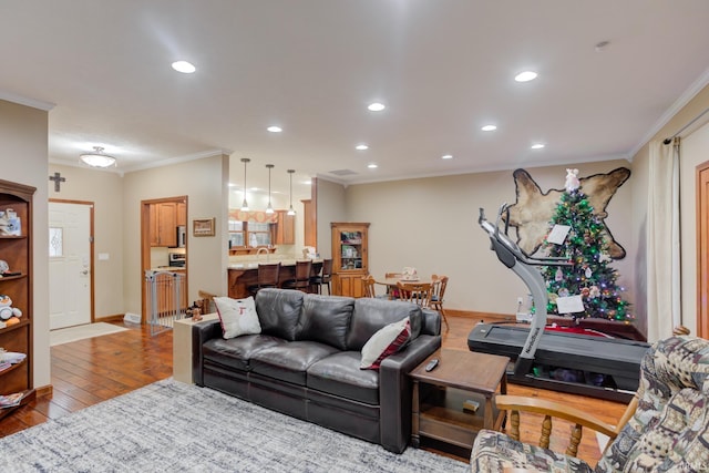 living room with light hardwood / wood-style floors and ornamental molding