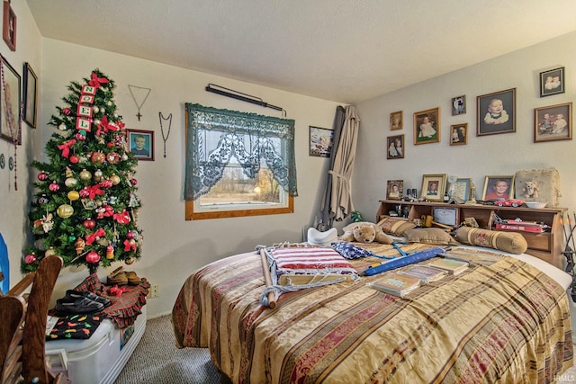 bedroom featuring carpet and a textured ceiling