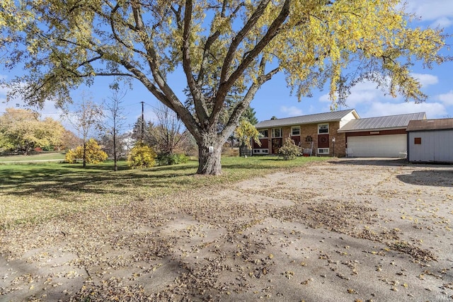 single story home featuring a garage and a front lawn