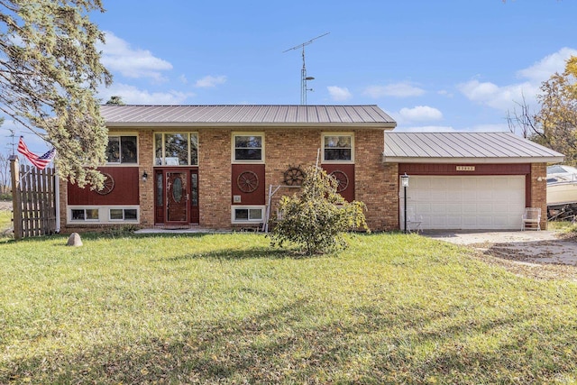 view of front of property with a front yard and a garage