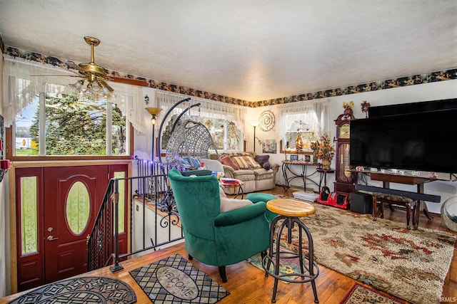 living room with hardwood / wood-style floors and ceiling fan