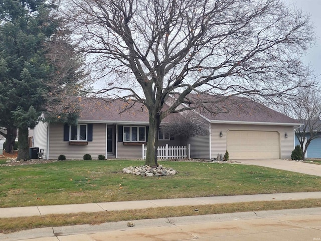 ranch-style home featuring a front yard and a garage