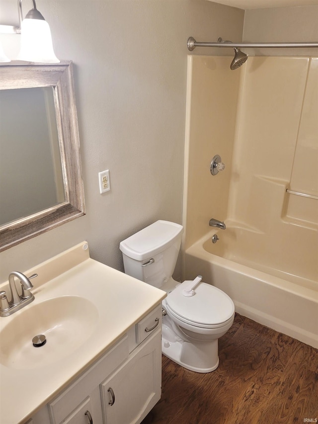 full bathroom with vanity, toilet, shower / bathing tub combination, and hardwood / wood-style flooring