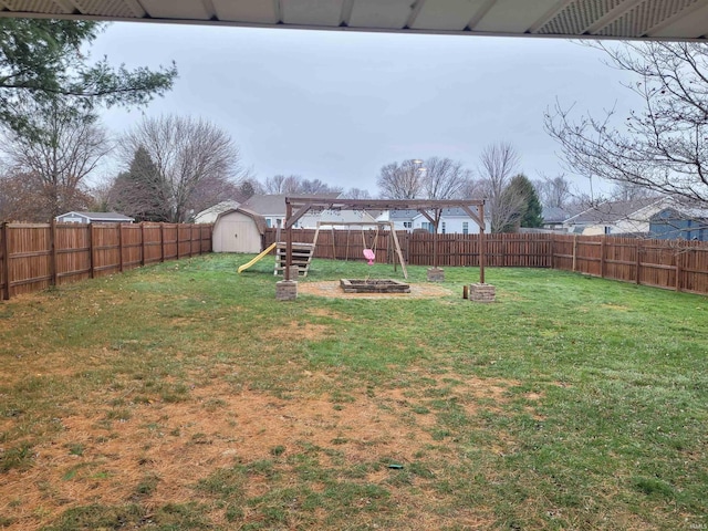 view of yard with a playground and a storage unit