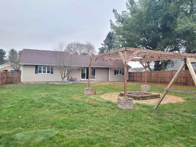 back of house with a yard and a pergola