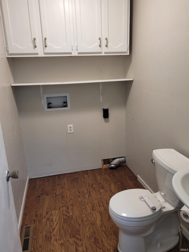 bathroom featuring hardwood / wood-style floors and toilet