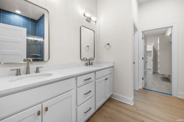 bathroom with vanity and hardwood / wood-style flooring