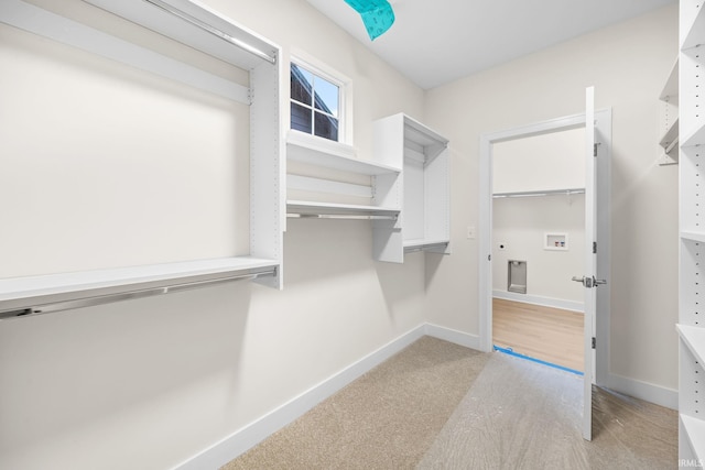 walk in closet featuring light hardwood / wood-style floors