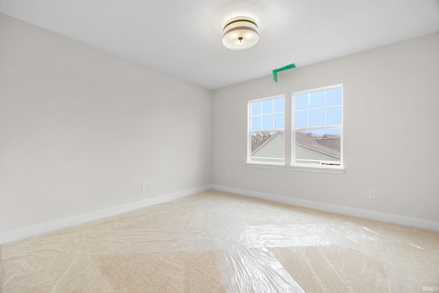 spare room featuring light colored carpet