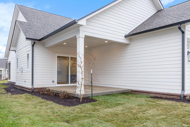 view of property exterior featuring a patio area and a yard