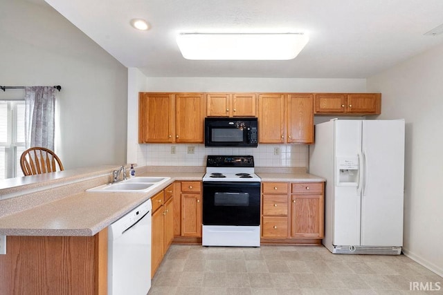 kitchen with decorative backsplash, white appliances, kitchen peninsula, and sink