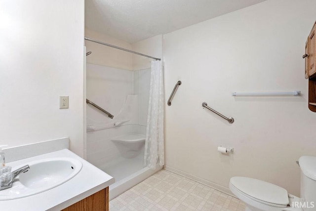 bathroom with a shower with shower curtain, vanity, and toilet