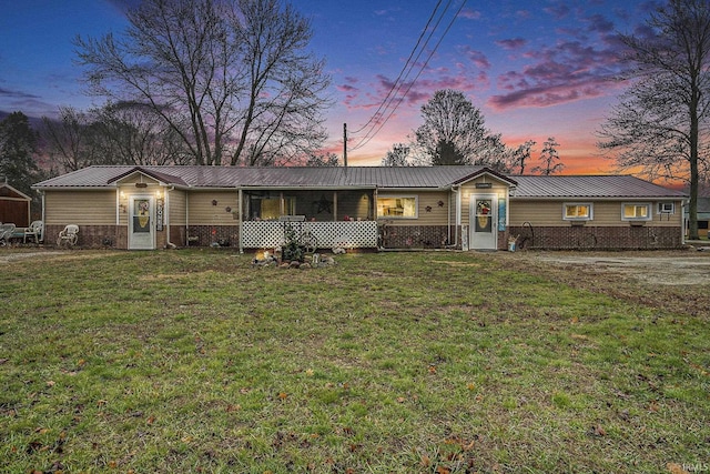 single story home with a lawn