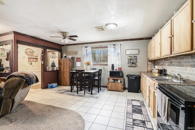 kitchen featuring light brown cabinetry, ceiling fan, sink, light tile patterned floors, and electric range