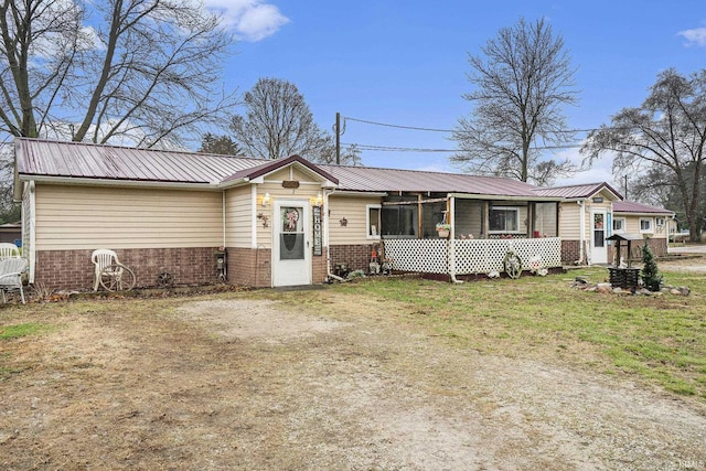 ranch-style home featuring a front yard and a sunroom