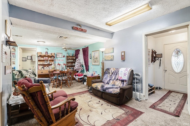 living room with carpet, ceiling fan, and a textured ceiling