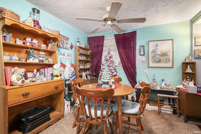 dining area featuring ceiling fan, carpet, and a textured ceiling