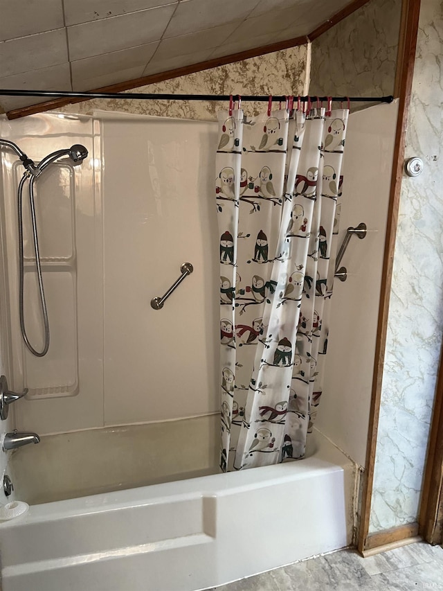 bathroom with shower / bath combination with curtain and lofted ceiling