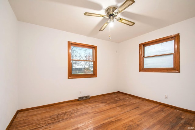 unfurnished room with ceiling fan and hardwood / wood-style floors