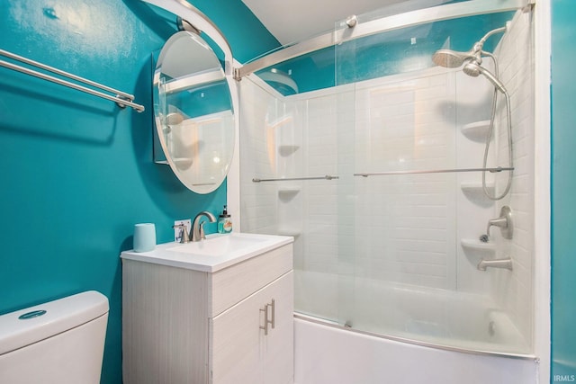 full bathroom featuring toilet, combined bath / shower with glass door, and vanity