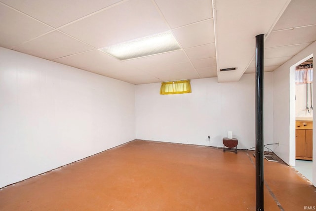 basement with a paneled ceiling