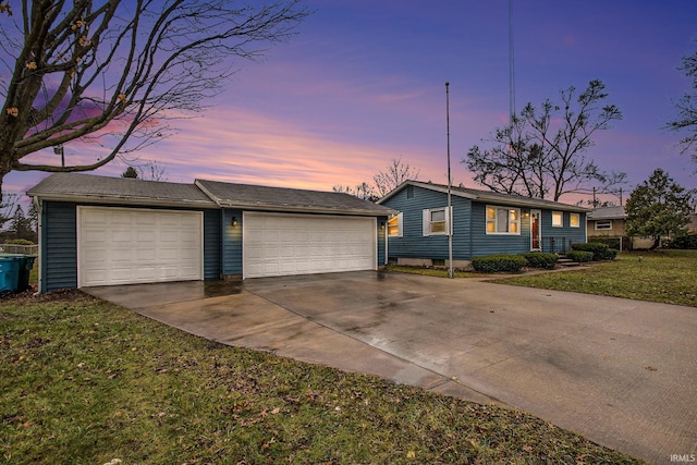 single story home with a yard and a garage