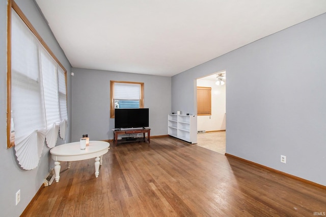 interior space with hardwood / wood-style floors and ceiling fan