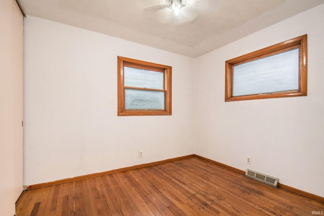 empty room featuring hardwood / wood-style floors and ceiling fan