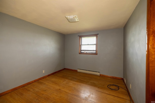 spare room with light wood-type flooring and baseboard heating