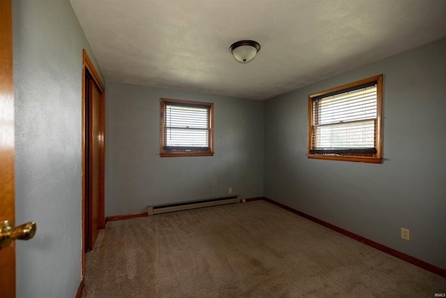 empty room featuring light carpet and a baseboard radiator