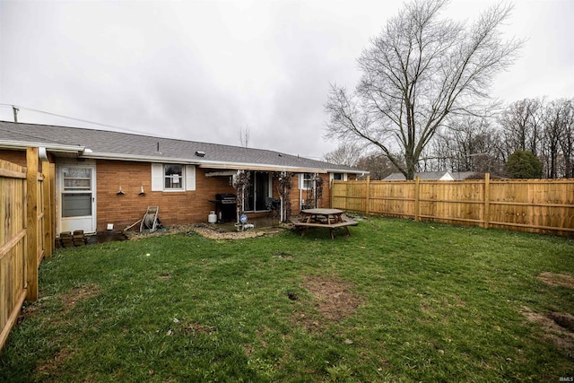 rear view of property featuring a yard