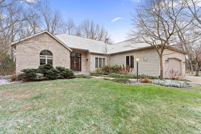 ranch-style home featuring a garage and a front yard