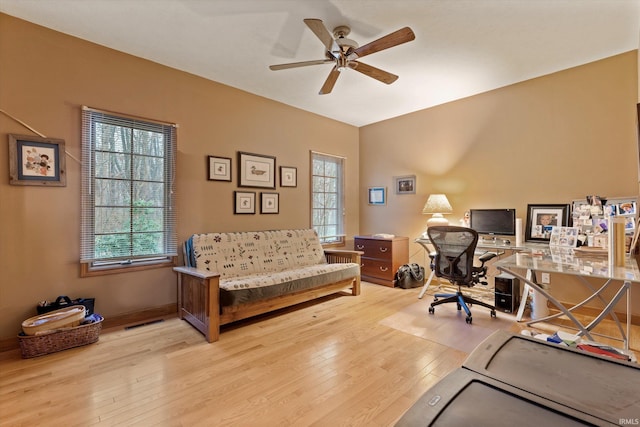 office featuring light hardwood / wood-style floors and ceiling fan